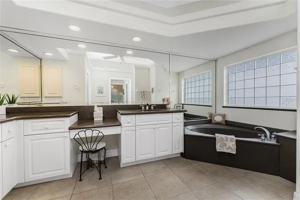 a kitchen with sink and white cabinets