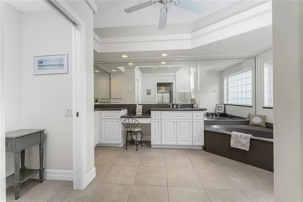 a bathroom with a granite countertop shower and a window