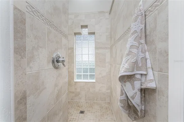 a spacious bathroom with a granite countertop sink and a mirror