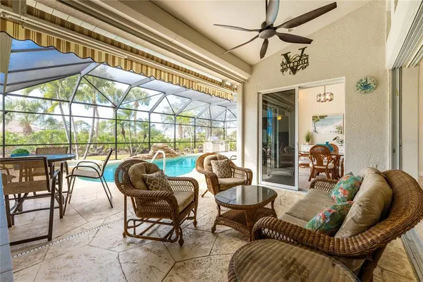 a view of a swimming pool with outdoor seating