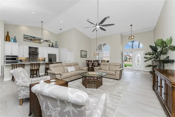 a living room with furniture a flat screen tv and a large window