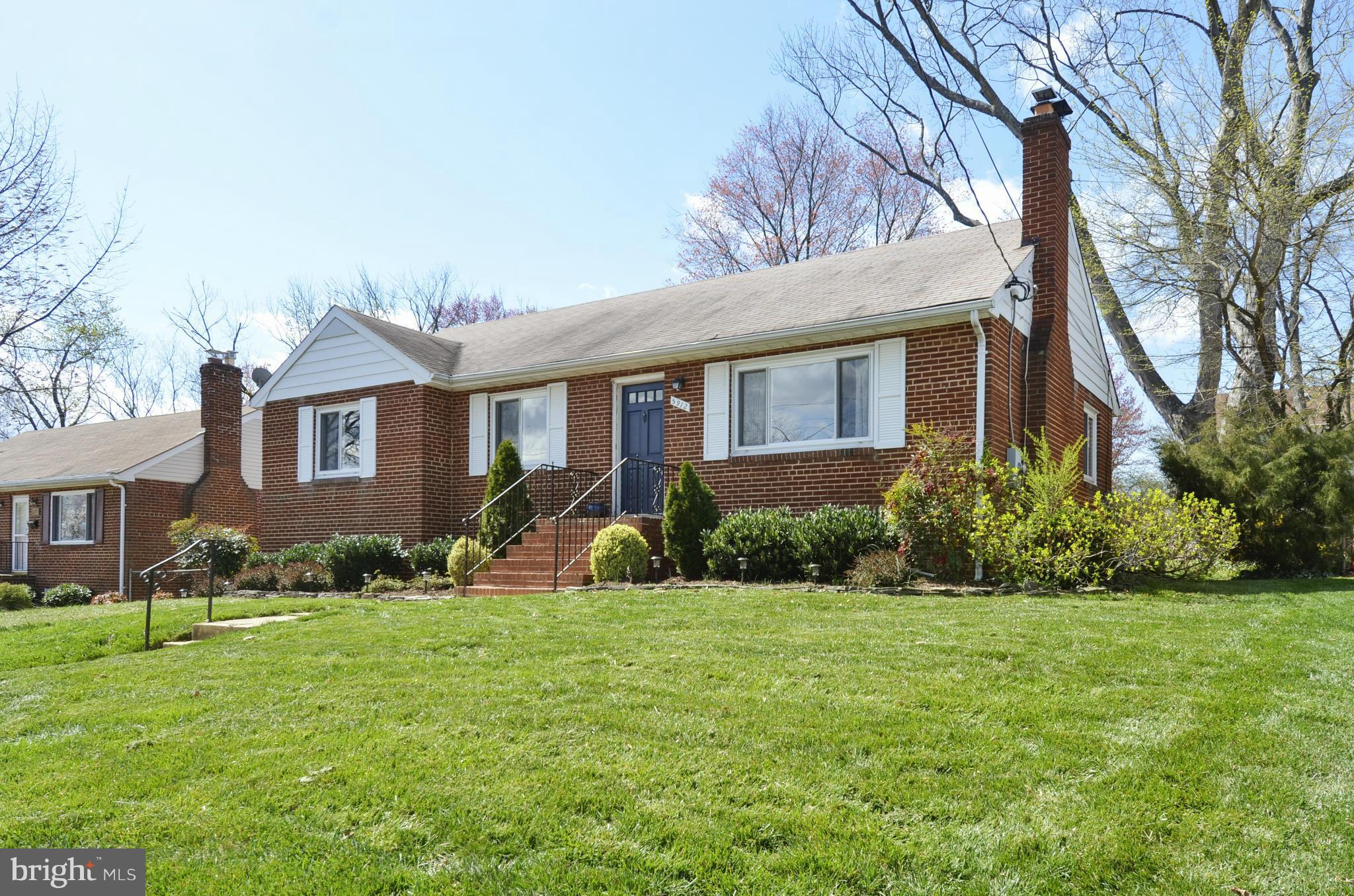5912 Craig Street Springfield, VA 22150 - Photo 1 of 24 a front view of a house with a yard and garage