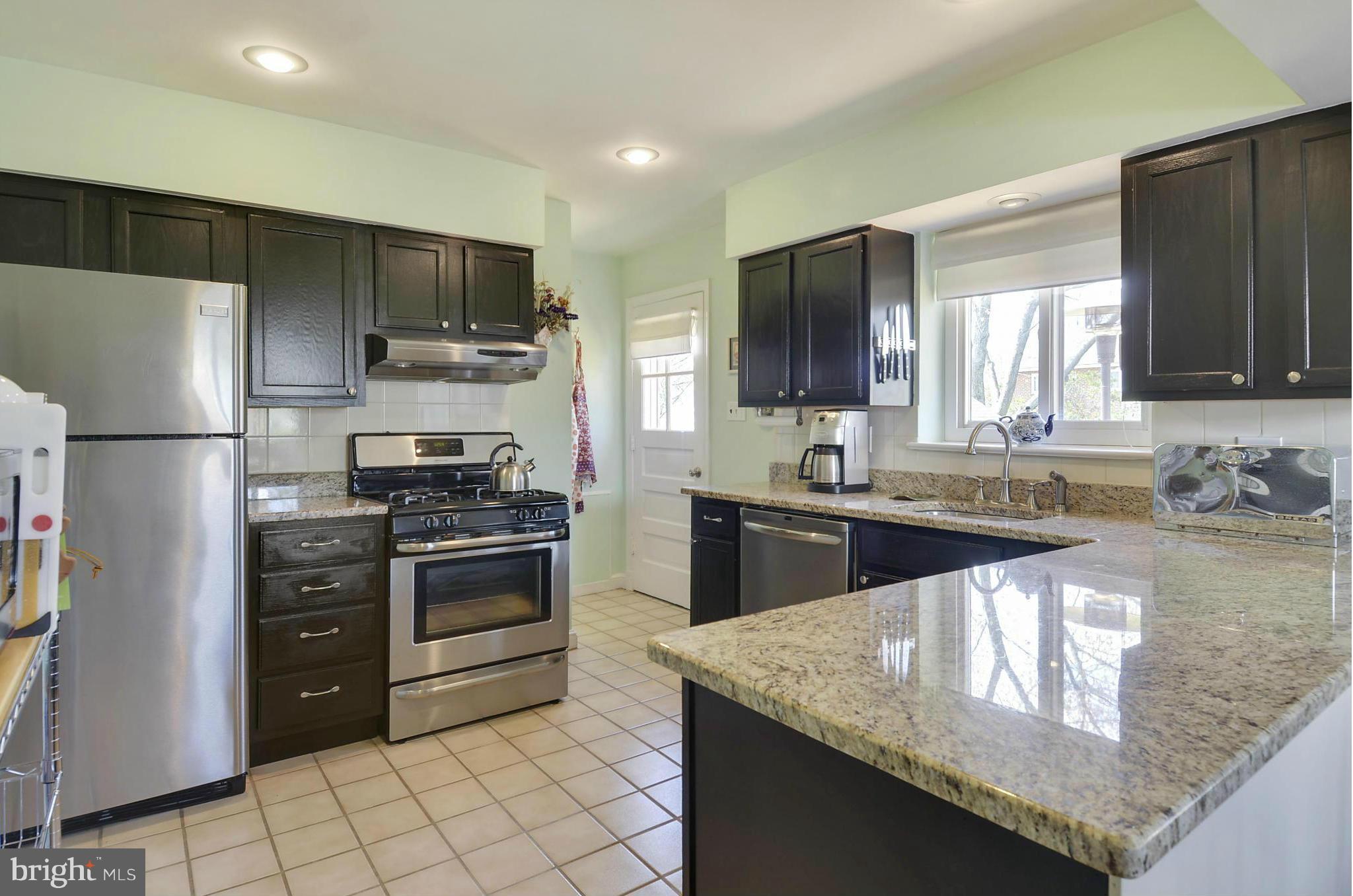 5912 Craig Street Springfield, VA 22150 - Photo 2 of 24 a kitchen with stainless steel appliances granite countertop a sink stove and refrigerator