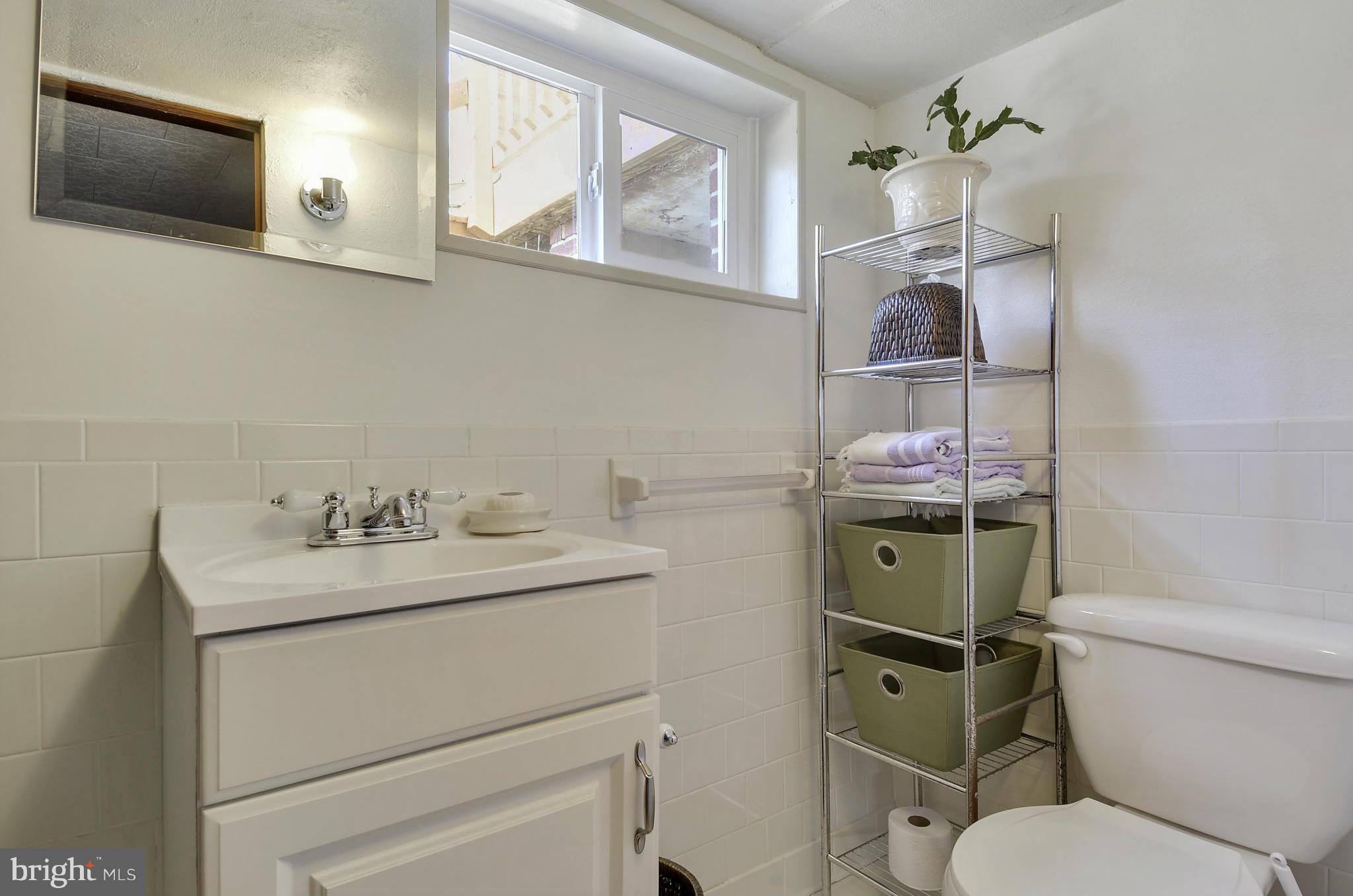 5912 Craig Street Springfield, VA 22150 - Photo 15 of 24 a bathroom with a toilet sink and mirror