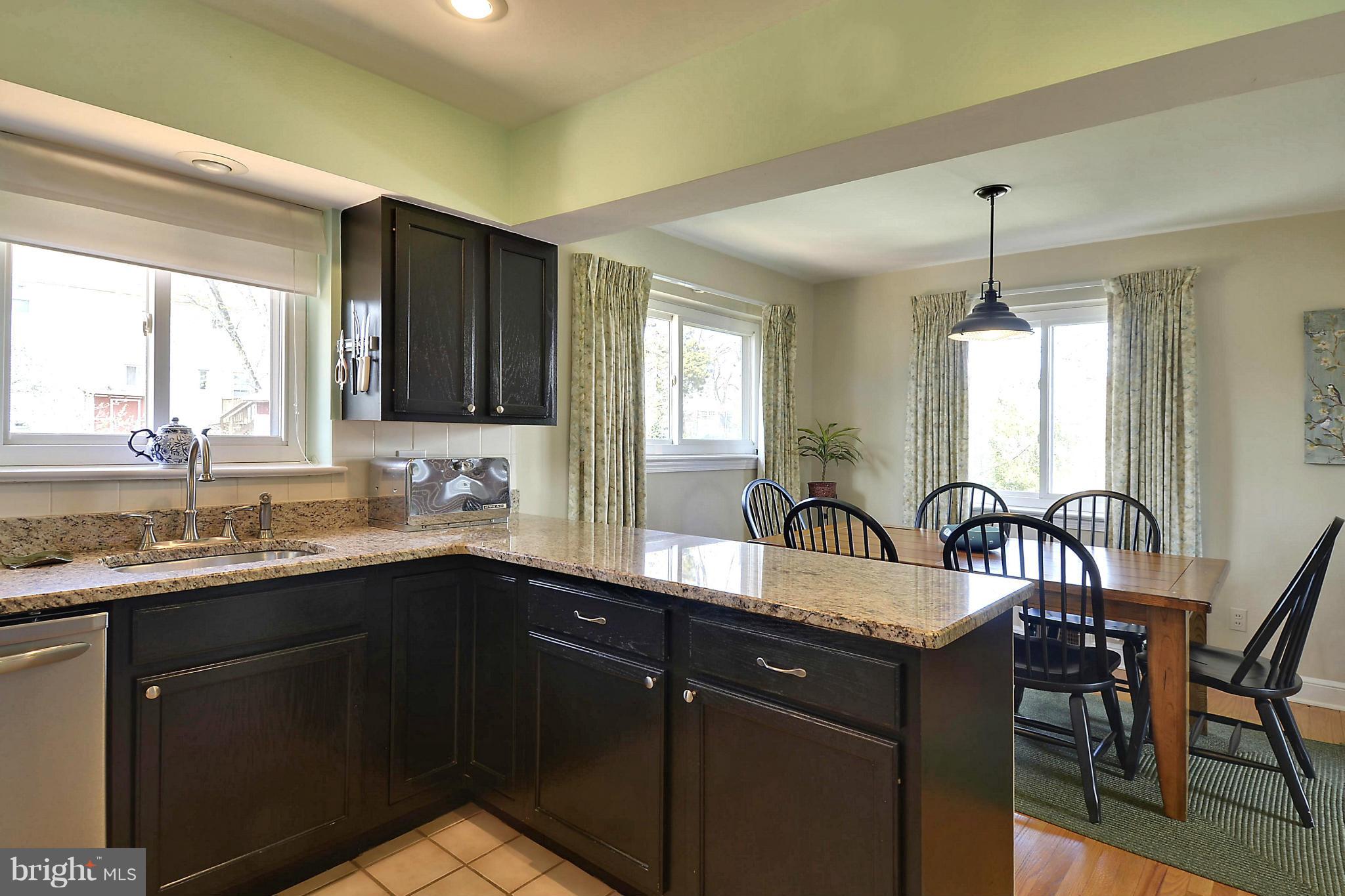 5912 Craig Street Springfield, VA 22150 - Photo 3 of 24 a kitchen with granite countertop a sink stainless steel appliances and cabinets
