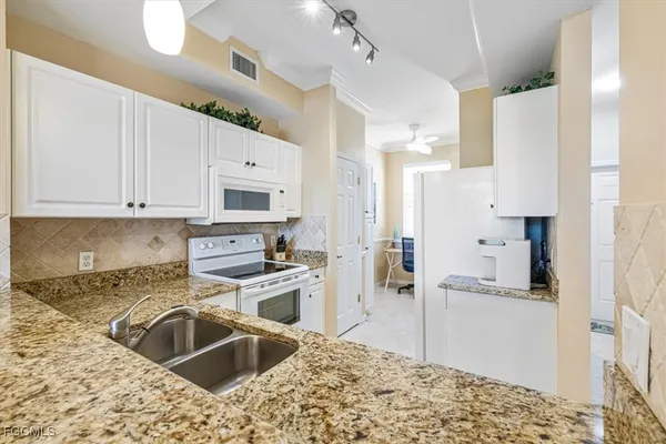 a kitchen with a sink stove and refrigerator