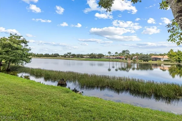 an aerial view of a city with lots of residential buildings ocean and mountain view in back