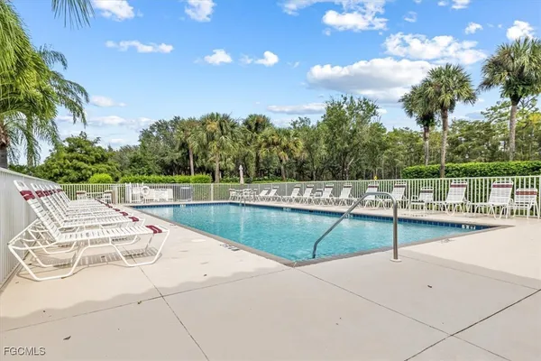 swimming pool view with a seating space and a garden view