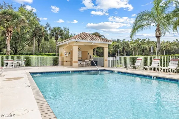 an aerial view of residential houses with outdoor space and swimming pool