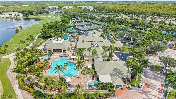 an aerial view of a house with a garden and lake view