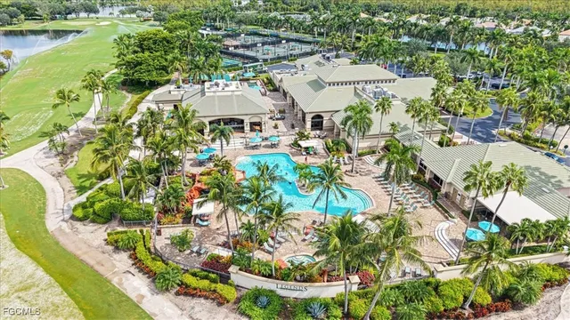 an aerial view of a house with a garden and lake view