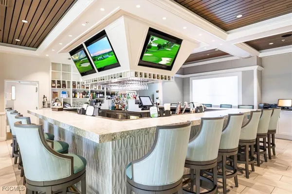 a outdoor space with lots of tables a chairs and a chandelier