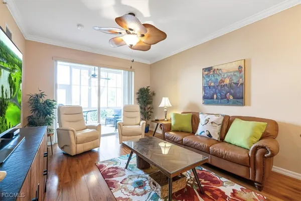 a living room with furniture a rug and a chandelier