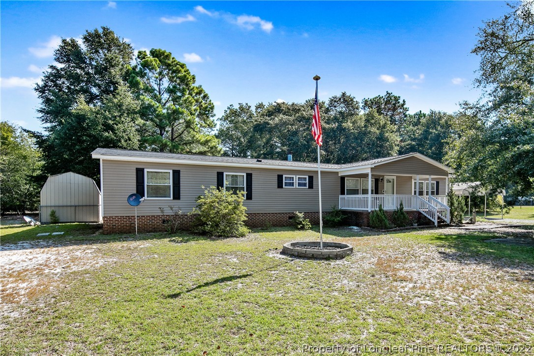 922 Magnolia Church Road Stedman, NC 28391 - Photo 1 of 49 a front view of a house with a yard and garage