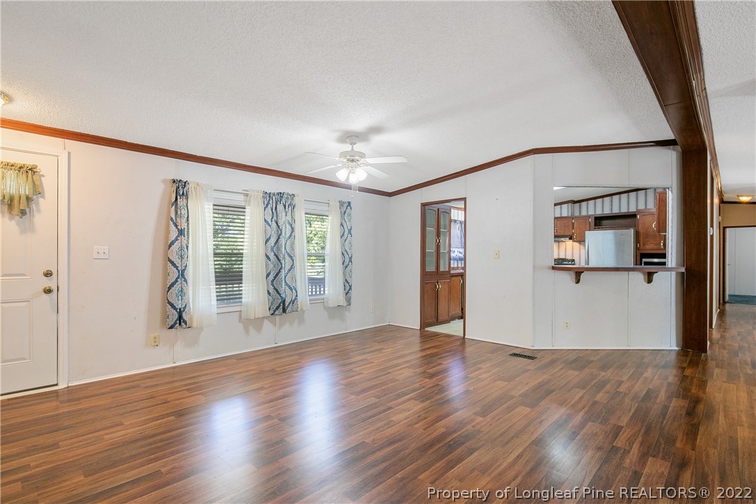 922 Magnolia Church Road Stedman, NC 28391 - Photo 11 of 49 an empty room with wooden floor and windows
