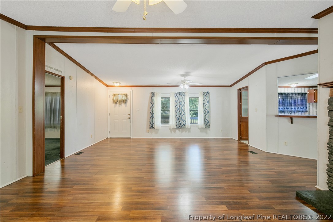 922 Magnolia Church Road Stedman, NC 28391 - Photo 13 of 49 a view of an empty room with wooden floor and a window