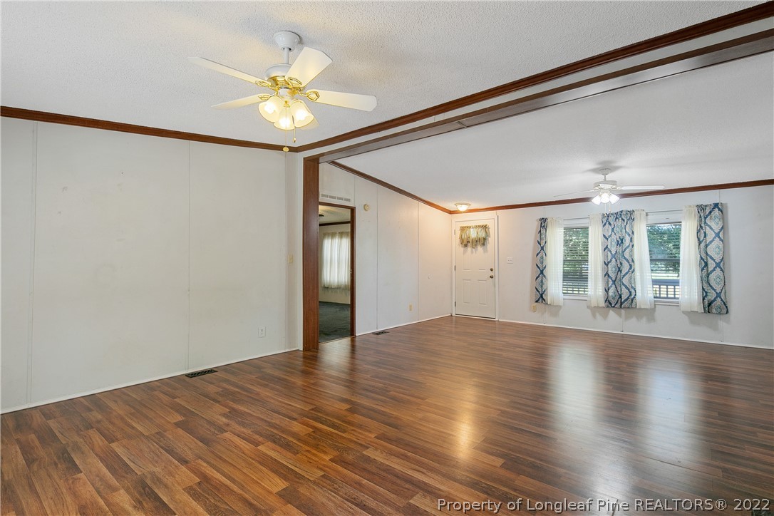 922 Magnolia Church Road Stedman, NC 28391 - Photo 14 of 49 a view of an empty room with wooden floor and a window
