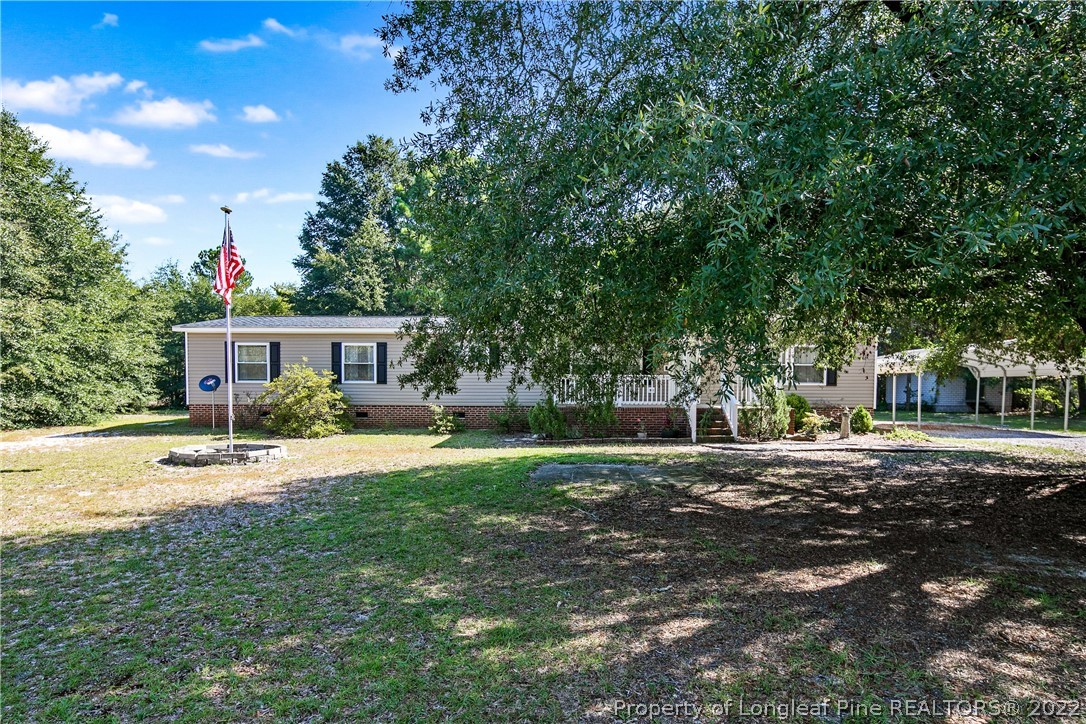 922 Magnolia Church Road Stedman, NC 28391 - Photo 2 of 49 a front view of house with yard and trees