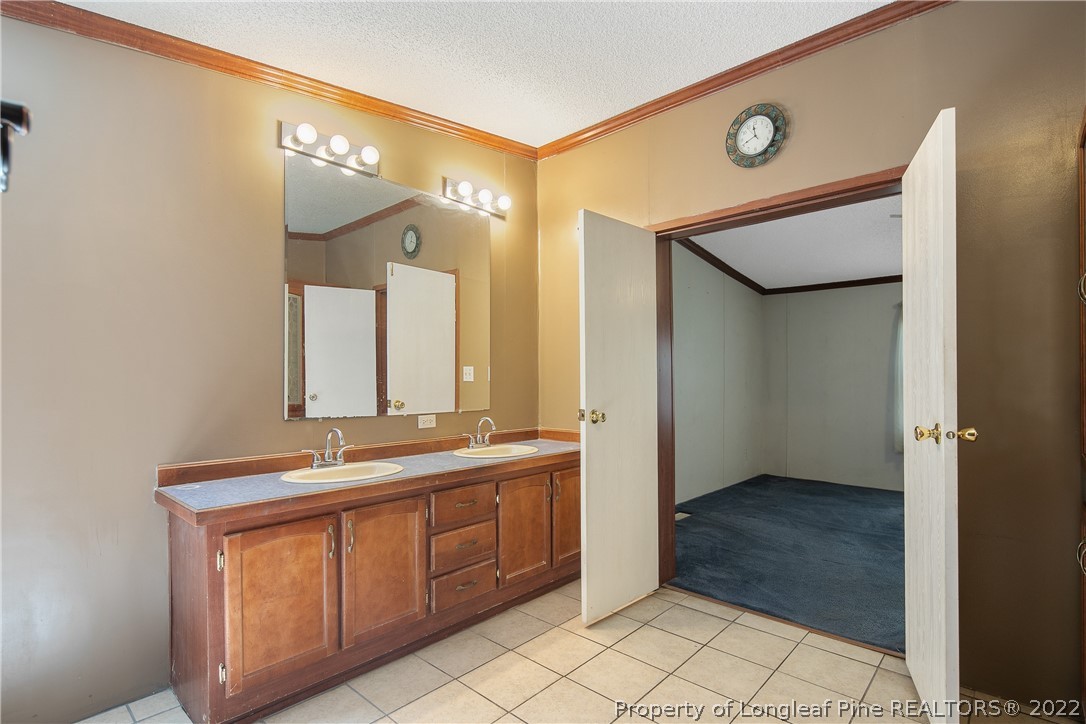922 Magnolia Church Road Stedman, NC 28391 - Photo 30 of 49 a bathroom with a double vanity sink mirror and