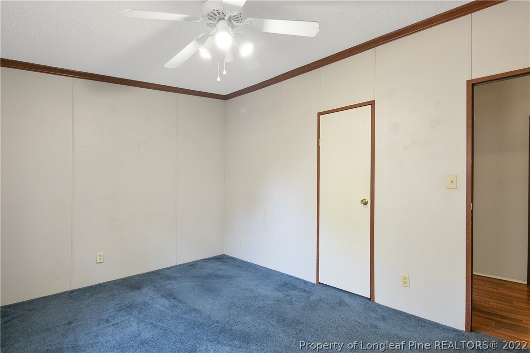 922 Magnolia Church Road Stedman, NC 28391 - Photo 43 of 49 an empty room with a ceiling fan and a window