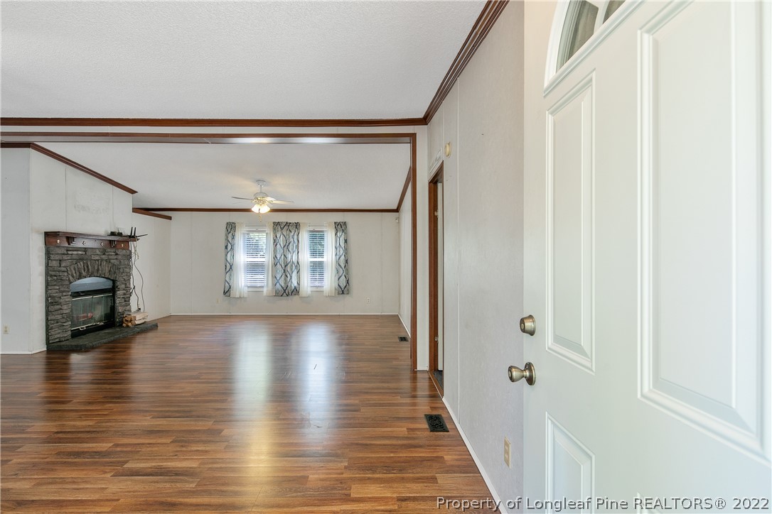 922 Magnolia Church Road Stedman, NC 28391 - Photo 6 of 49 a view of a hallway with wooden floor and staircase