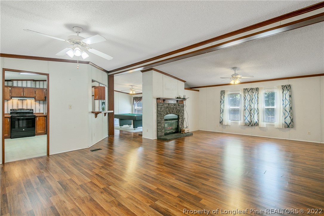 922 Magnolia Church Road Stedman, NC 28391 - Photo 7 of 49 a view of an empty room with wooden floor and a window