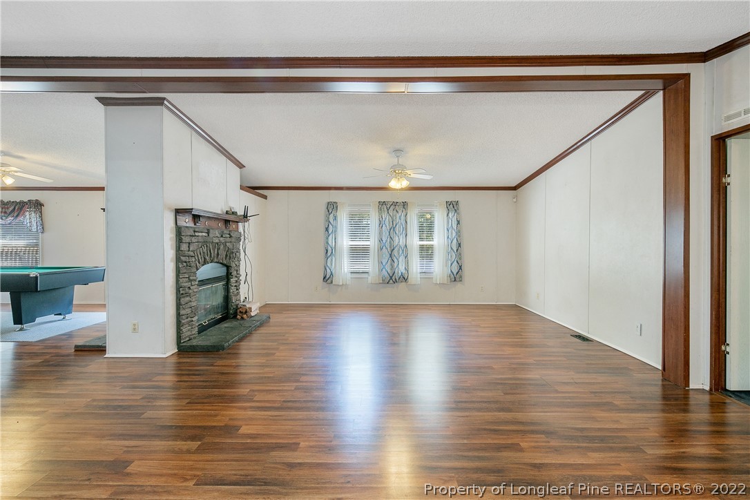 922 Magnolia Church Road Stedman, NC 28391 - Photo 8 of 49 a view of an empty room with wooden floor and a window
