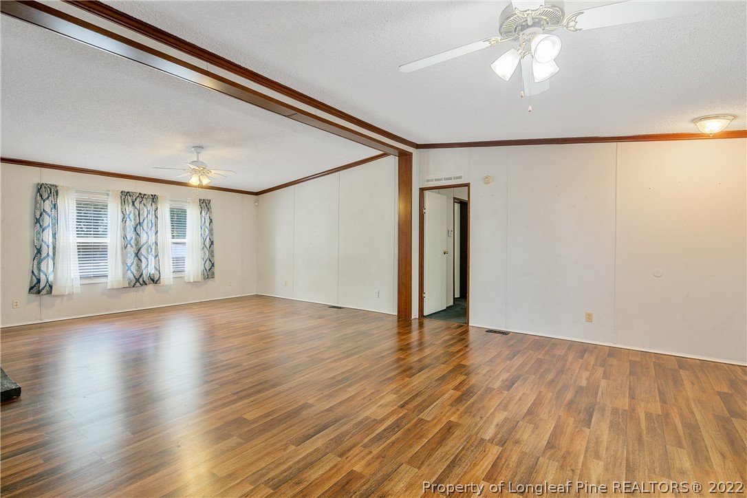 922 Magnolia Church Road Stedman, NC 28391 - Photo 9 of 49 a view of an empty room with wooden floor and a window