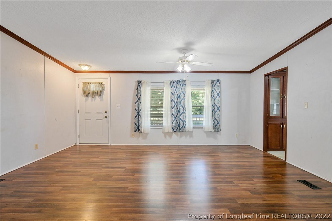 922 Magnolia Church Road Stedman, NC 28391 - Photo 10 of 49 a view of an empty room with wooden floor and a window
