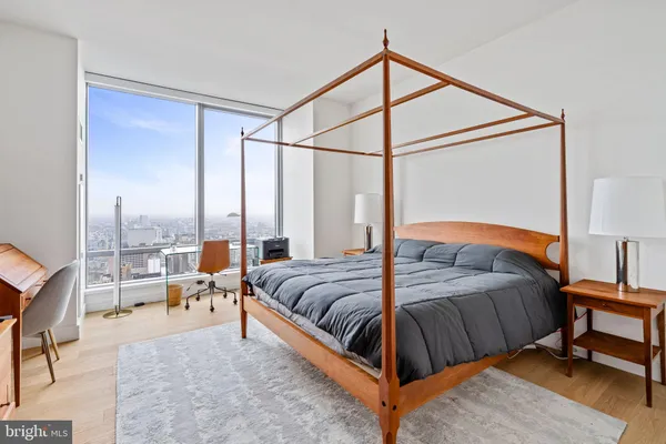 a bed room with a bed and a chair