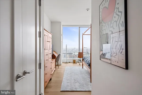 a living room with furniture and a painting on the wall