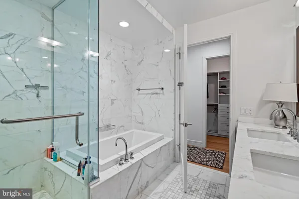 a bathroom with a tub a sink and a shower