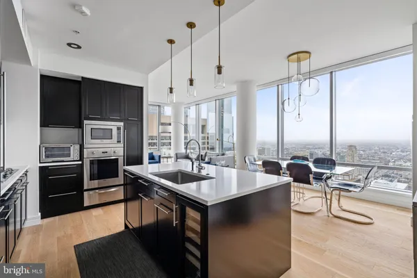 a kitchen with stainless steel appliances granite countertop a sink a stove and a refrigerator