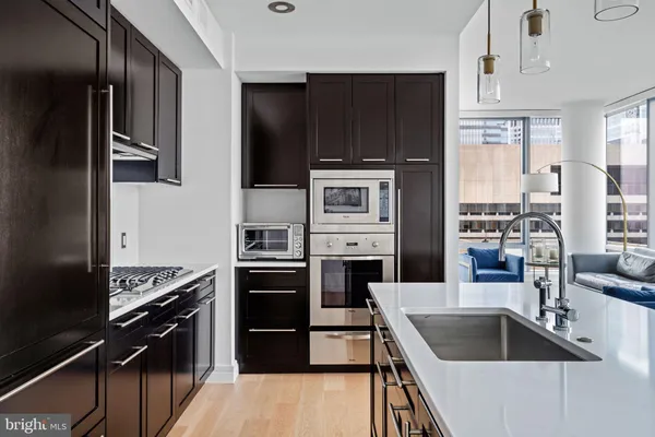 a kitchen with kitchen island granite countertop a stove and a refrigerator