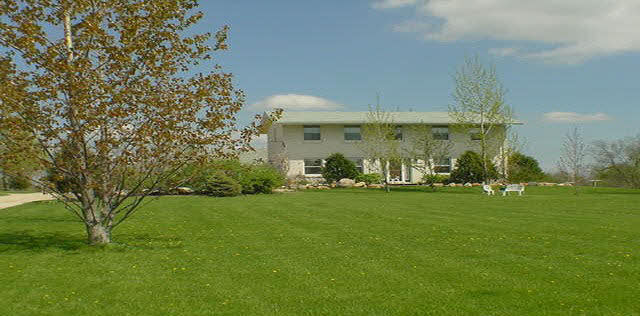 16955 Hartman Road Davis, IL 61019 - Photo 1 of 5 a backyard of a house with lots of green space
