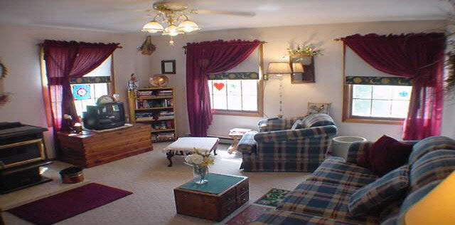 16955 Hartman Road Davis, IL 61019 - Photo 2 of 5 a living room with furniture a chandelier and a window