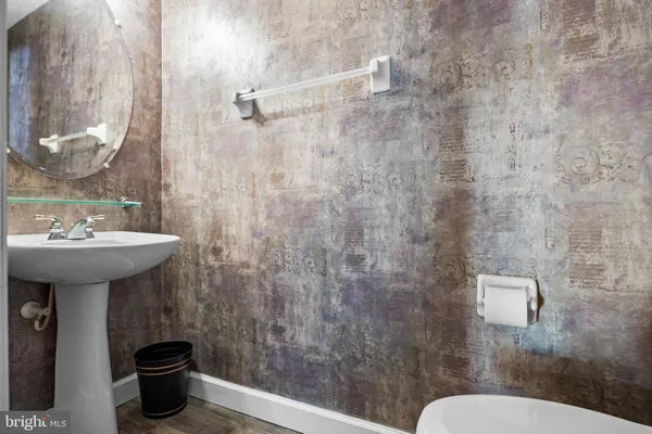 a bathroom with a sink toilet and a mirror