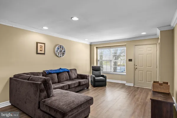 a living room with furniture window and wooden floor