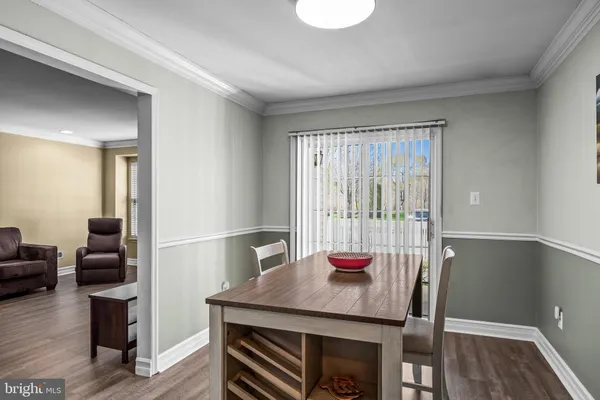 a view of a room with furniture and wooden floor