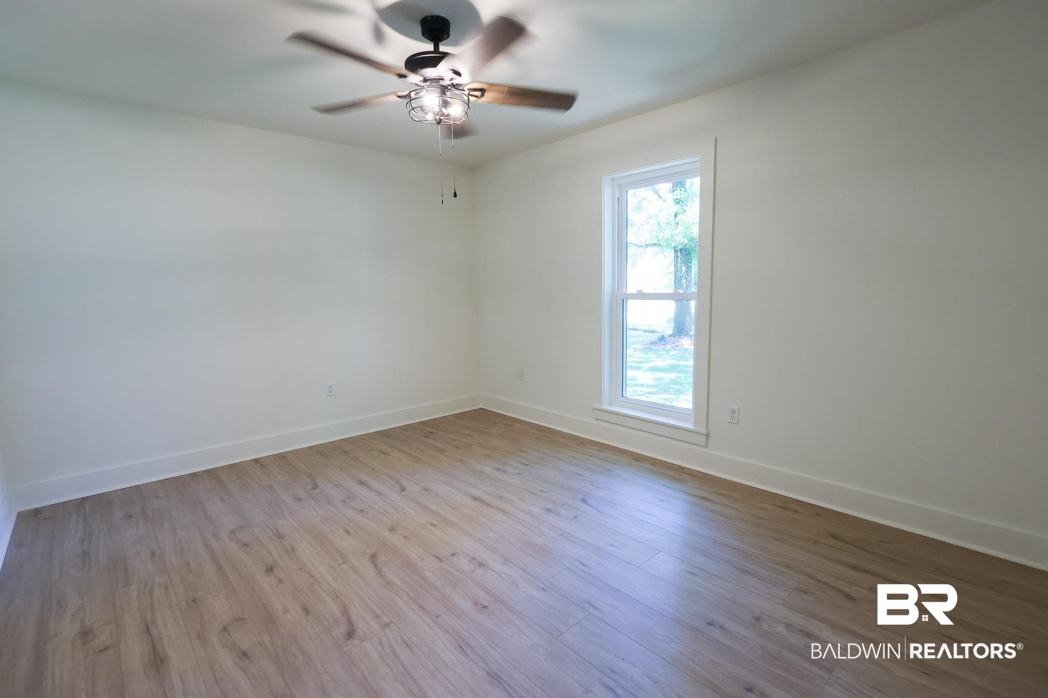 12190 Pecan Grove Street Magnolia Springs, AL 36555 - Photo 17 of 45 Empty room with wood-type flooring and ceiling fan