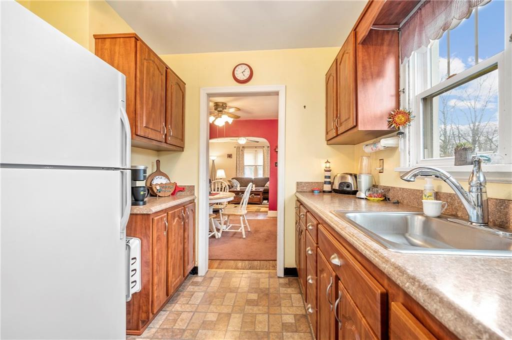 100 Frank Circle Rochester, PA 15074 - Photo 10 of 25 a kitchen with stainless steel appliances granite countertop a sink and a refrigerator