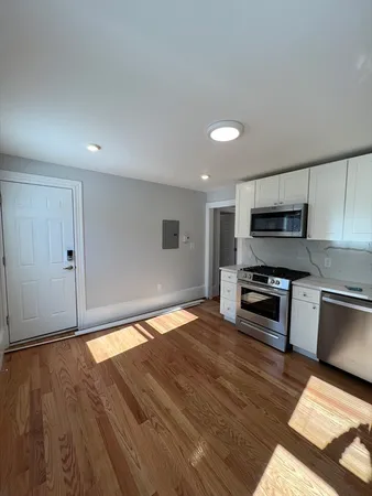 a kitchen with granite countertop a stove and cabinets