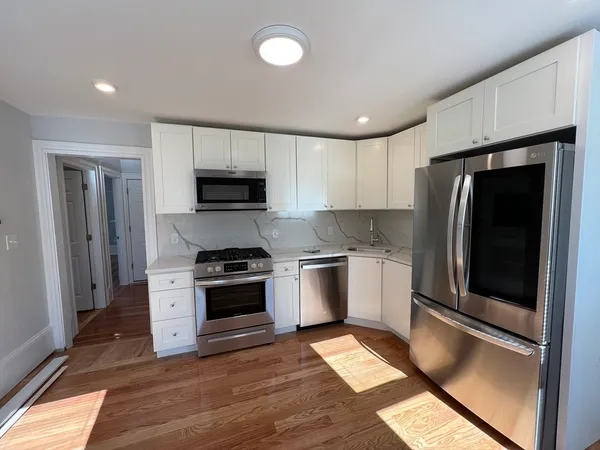 a kitchen with granite countertop a stove and a microwave