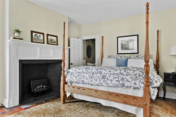 a bedroom with a bed and a fireplace