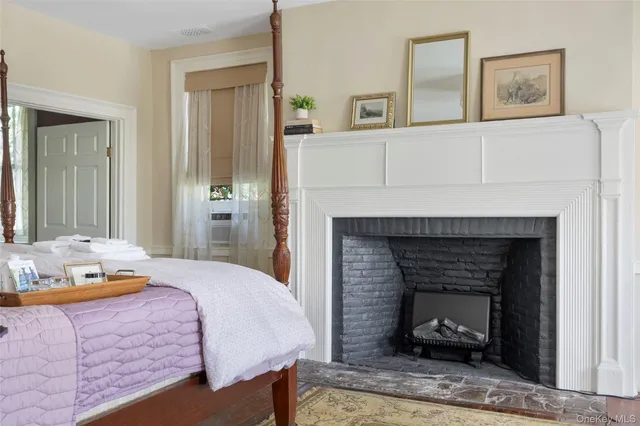 a bedroom with a bed and a fireplace