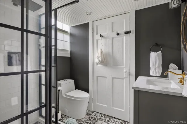 a bedroom with a bed and large windows