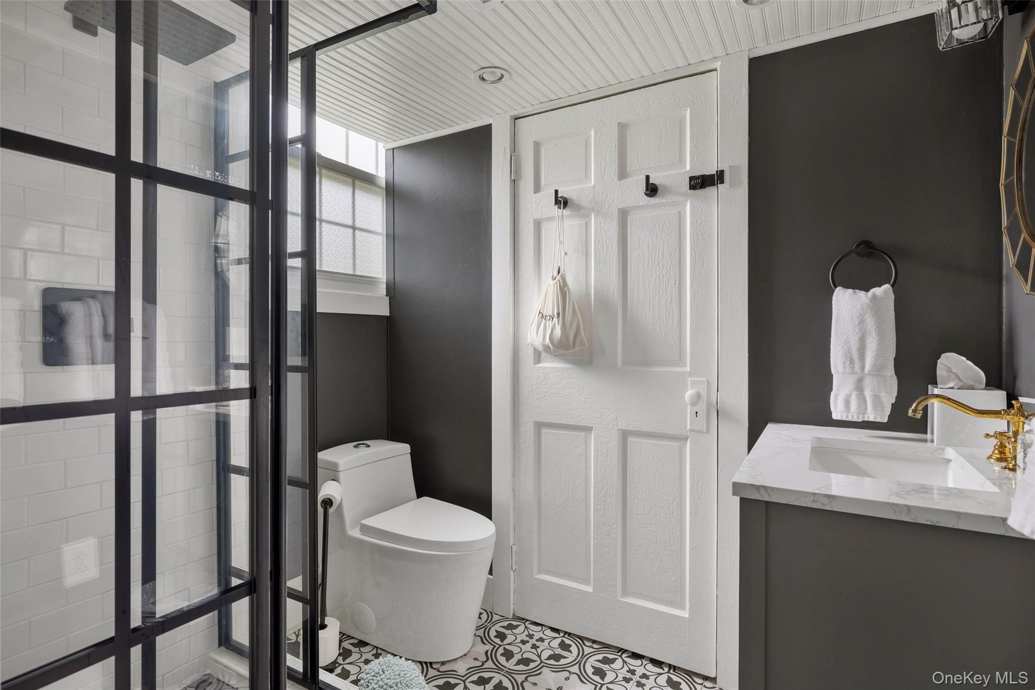 4494-4496 Highway 209 Stone Ridge, NY 12484 - Photo 22 of 48 a bathroom with a toilet sink a shower and a mirror