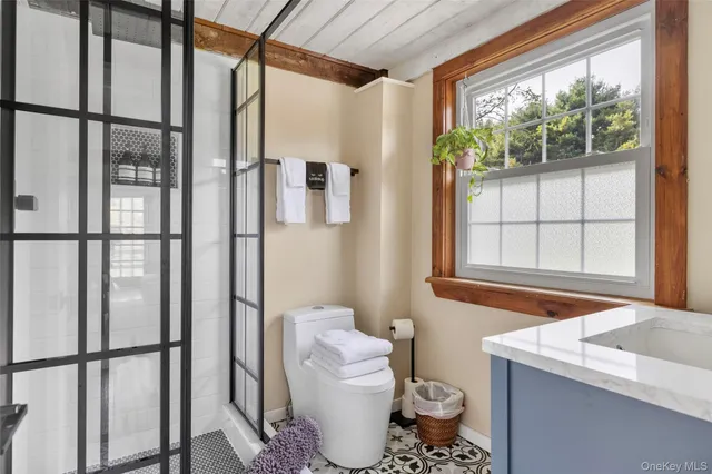 a bathroom with a granite countertop sink a mirror and a window