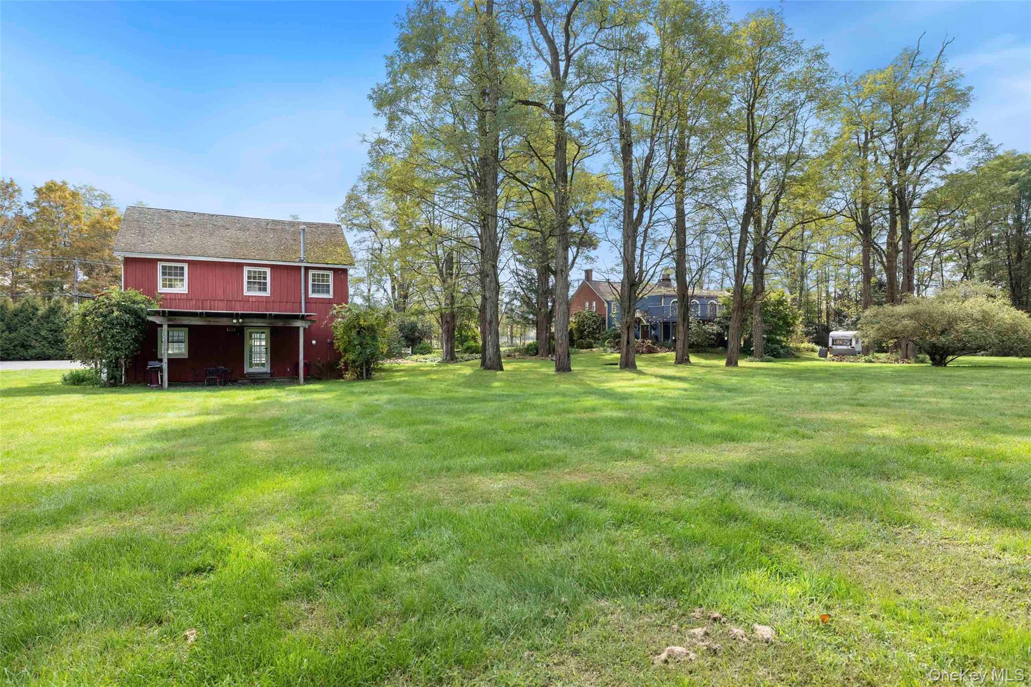 4494-4496 Highway 209 Stone Ridge, NY 12484 - Photo 34 of 48 a red brick house with a big yard and large trees