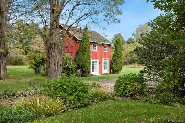 a view of a porch with furniture and garden